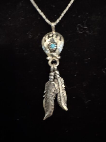 Beautiful sterling silver bear claw with feathers and turquoise