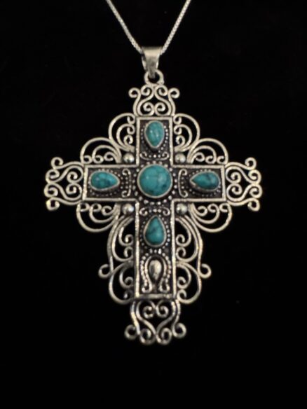Intricate sterling silver cross with turquoise.