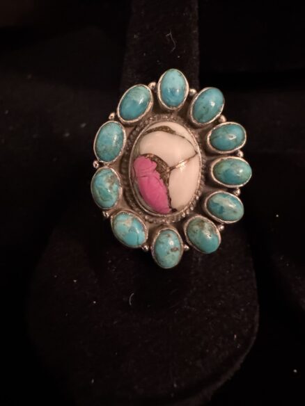 Stunning, cotton, candy, turquoise surrounded by turquoise stones sat in sterling silver